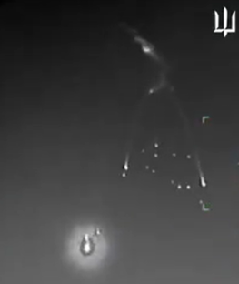 Night vision image of multiple meteorites falling from the sky.