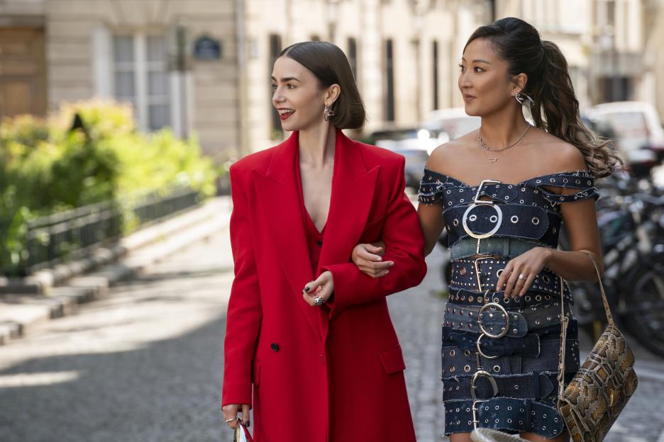 Emily and Mindy walking arm in arm from Emily in Paris.