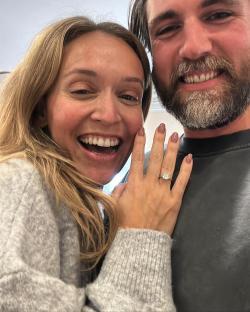 Close-up selfie of an engaged couple.