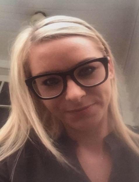 Photo of a blonde woman wearing glasses.