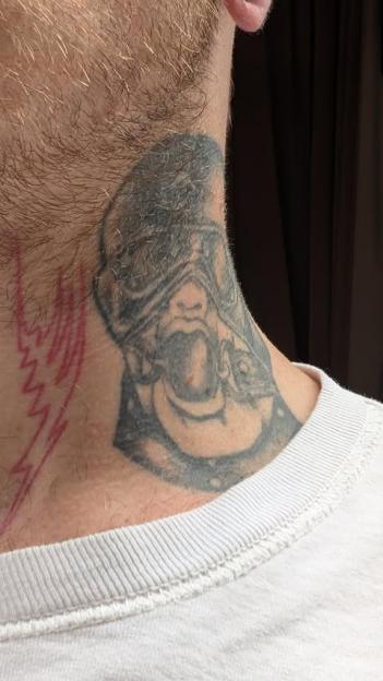 Neck tattoo of a helmeted figure and a lightning bolt.