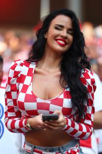 Woman in Croatian checkered top using a smartphone.
