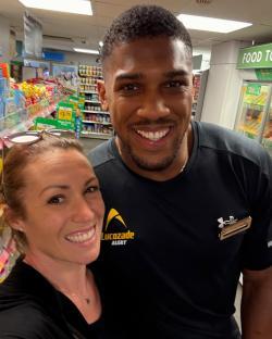 Anthony Joshua with a customer at a Morrisons supermarket.