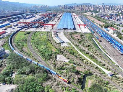 Aerial view of a freight train departing from a station in Chongqing, China.