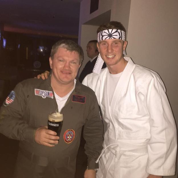 Ricky Hatton in a "Top Gun" costume holding a Guinness, with Brad Rea dressed as a karate kid.