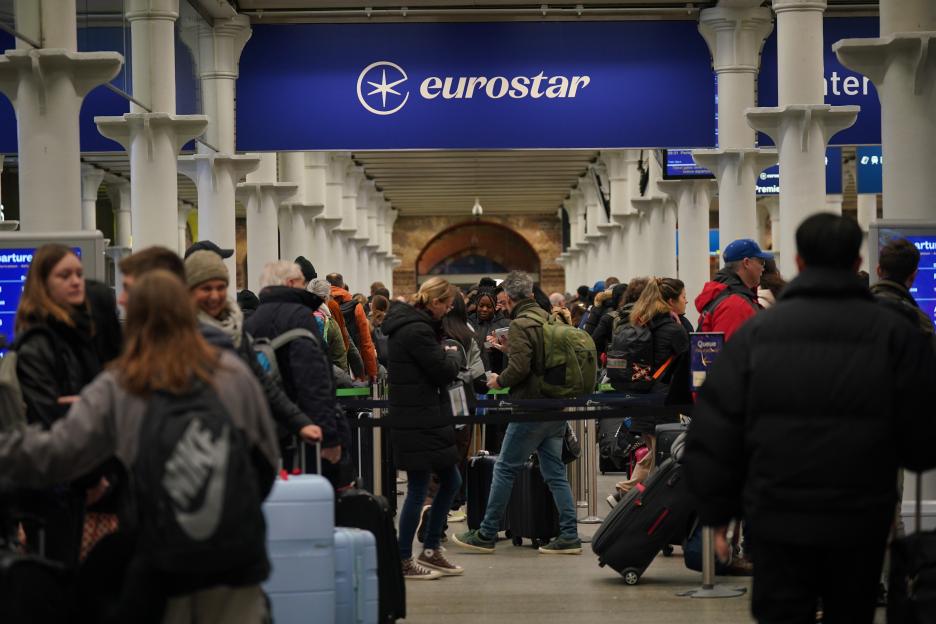 Passengers in line at the Eurostar terminal in St Pancras International station, central London. Eurostar have announced all of its services will resume on Sunday after flooding in tunnels under the River Thames was brought under control, although speed restrictions may lead to delays. Picture date: Sunday December 31, 2023. PA Photo. The New Year's Eve travel plans of thousands of people may be back on course after Eurostar said the "unprecedented" flooding has been brought under control meaning "at least one tunnel can now be used", but warned customers to expect further delays and busy stations. See PA story TRANSPORT NewYear. Photo credit should read: Yui Mok/PA Wire