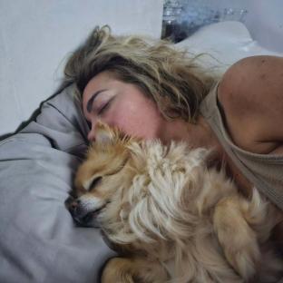 Woman sleeping with her dog.