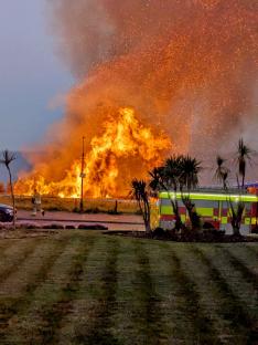 Moment fire erupts on beach as major blaze seen along tourist hotspot seafront with fears it was started deliberately