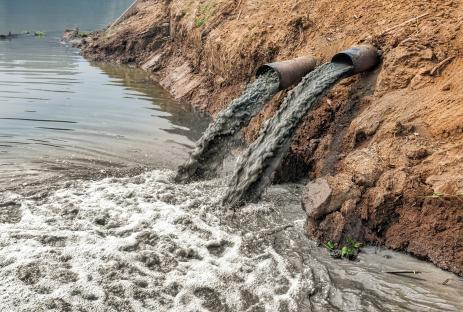 Industrial wastewater being discharged into a river.