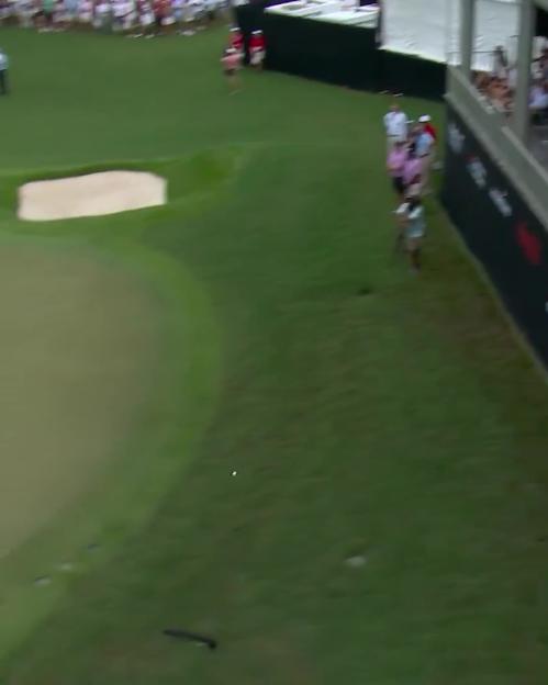 Rory McIlroy making a trick shot on a golf course.
