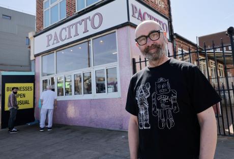 Man standing in front of Pacitto shop in Redcar.