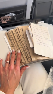 Hand holding stack of handwritten marriage advice notes.
