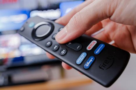 Hand holding an Amazon Fire TV remote.