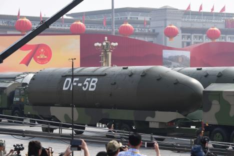 DF-5B intercontinental ballistic missiles on military transport vehicles in Tiananmen Square during a military parade.