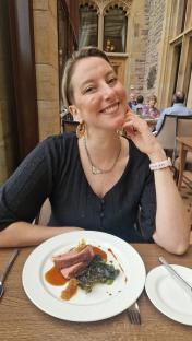Woman enjoying a meal at a restaurant.