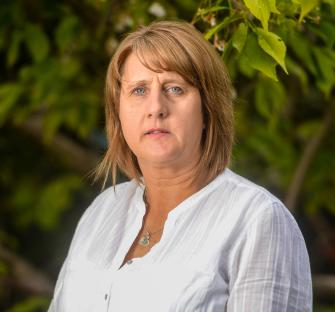 Photo of a woman wearing a white shirt.