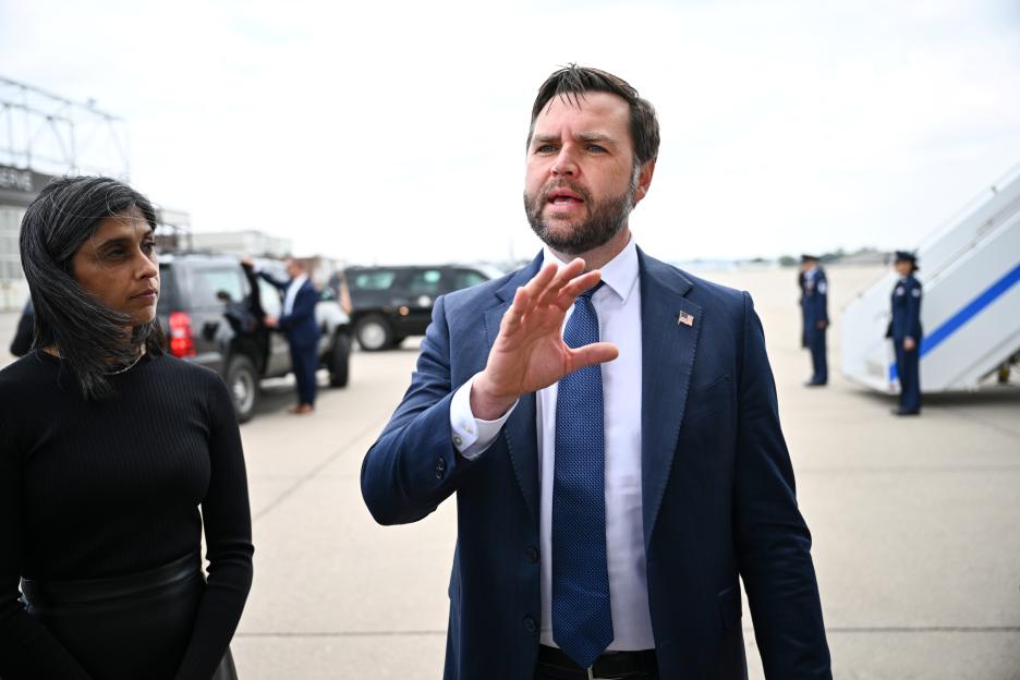 U.S. Vice President JD Vance speaks to the press at an airport.