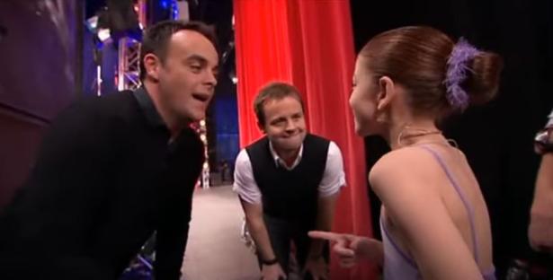 A young girl in a leotard with two men, one of whom is Ant McPartlin, on Britain's Got Talent.