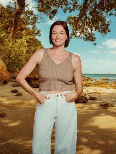 Woman standing on a beach.