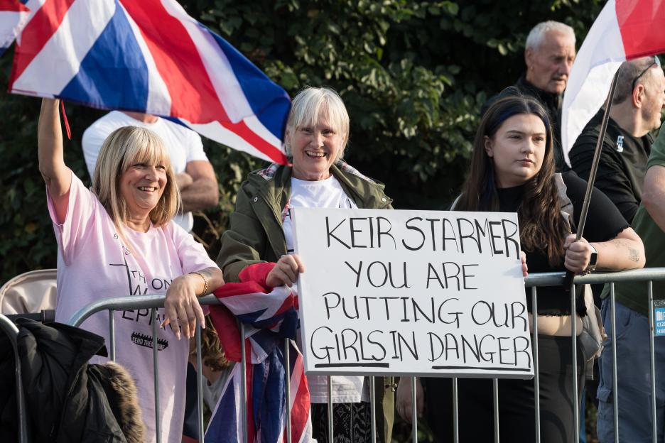 Protestors holding signs that read "Keir Starmer you are putting our girls in danger".