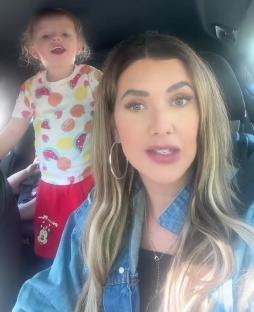 Woman and young child in a car; text overlay reads