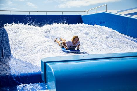Person bodyboarding on artificial wave.