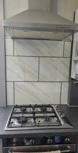 Kitchen makeover: new stove and marble-look backsplash.