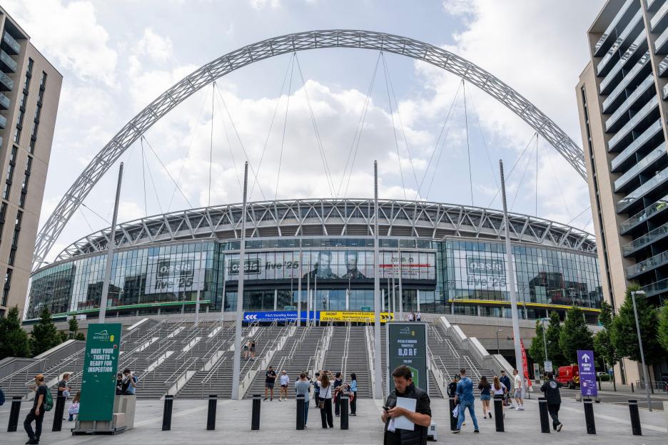 Fans arriving at Wembley Stadium for an Oasis concert.