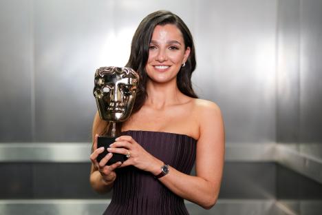 Marisa Abela holding a BAFTA award.