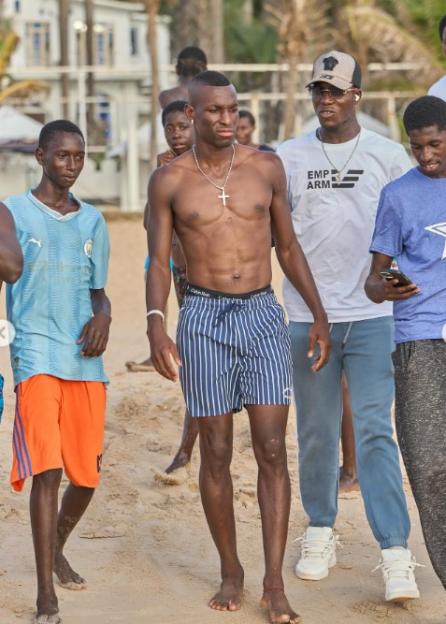 Nicolas Jackson walking on a beach.