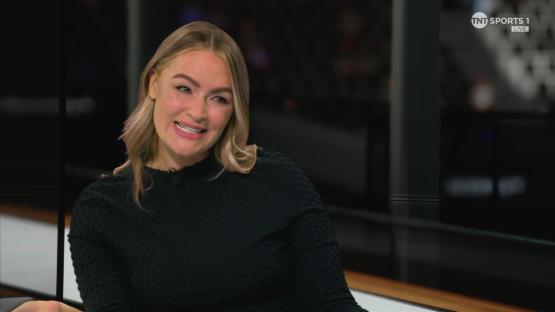 Woman smiling on a TV show.