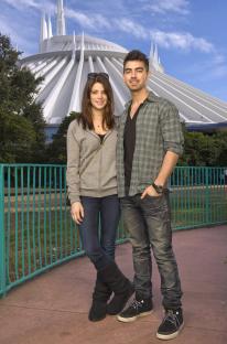 a man and a woman standing in front of a building