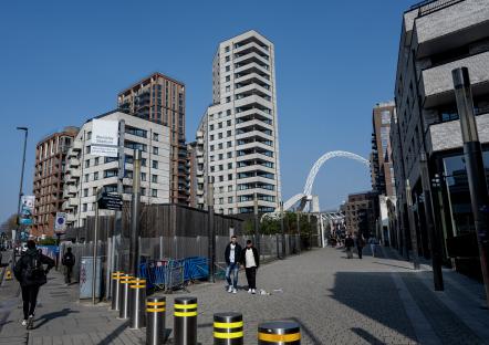 View of Wembley, North West London, showing modern buildings and a pedestrian walkway.
