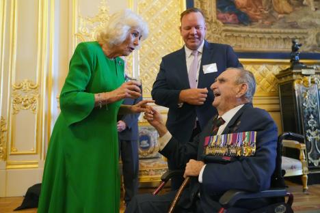 Queen Camilla speaking with Keith Payne V.C. at Windsor Castle.