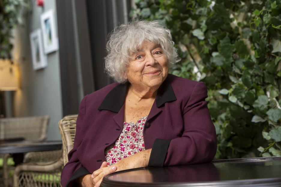 Miriam Margolyes sitting at a table.