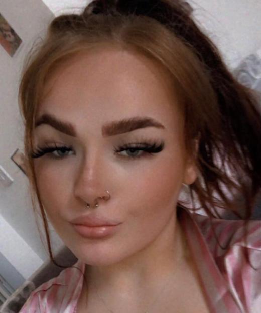 Abbie Jones with long dark eyelashes and a nose ring.