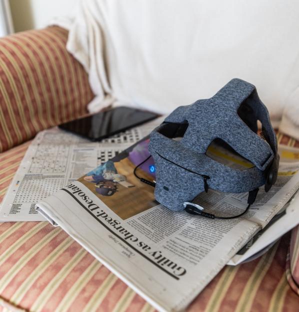 EEG headset on newspaper and tablet.