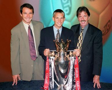 Gary Lineker with Alan Hansen and Mark Lawrenson presenting a trophy.