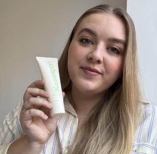 Woman holding Kosasport Chemistry deodorant.
