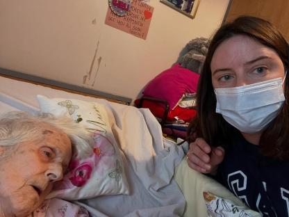A granddaughter says goodbye to her dying grandmother in a hospital bed.