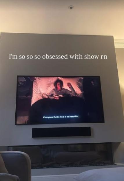 Photo of a TV screen showing a scene from a show, with the caption "I'm so so so obsessed with show rn" above it.