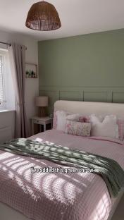 Bedroom makeover with green wall and pink bedding.