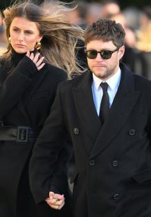 Niall Horan and Amelia Woolley holding hands at Liam Payne's funeral.