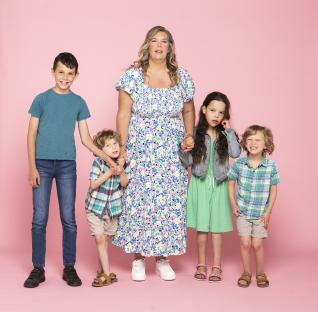Mother and her four children posing together.