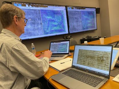 Librarian using imaging technology to analyze a faded Magna Carta.