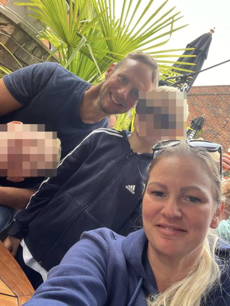 Photo of a man and woman with two children.