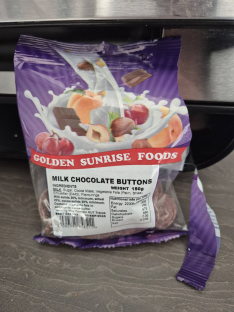 Package of Golden Sunrise Foods milk chocolate buttons.