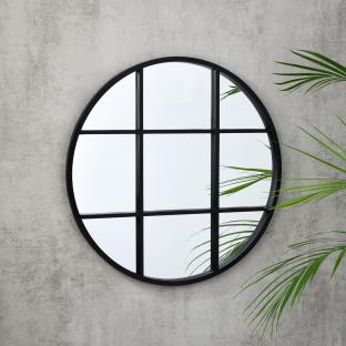Round mirror with black grid frame.