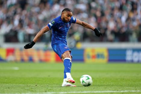 Christopher Nkunku of Chelsea shoots the ball during a soccer match.