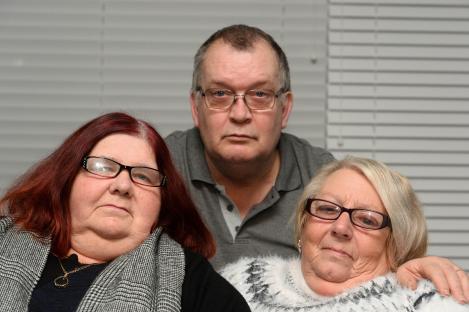 Parents of murder victims at a press conference.